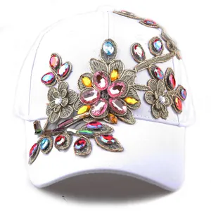 Detailed embroidery of colorful rhinestone flowers on a white cotton baseball cap