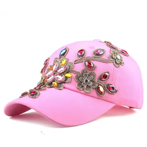 Detailed view of pink cotton baseball cap with 3D floral embroidery and colorful rhinestones