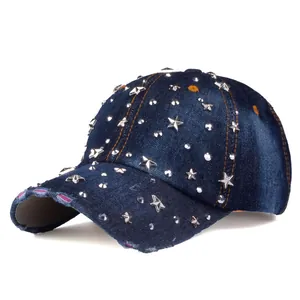 Detail of blue denim baseball cap featuring silver star rivets and frayed edge details