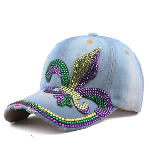 Detailed view of light blue denim baseball cap with colorful rhinestone fleur-de-lis pattern