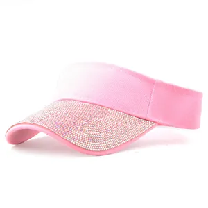 Detail of pink visor cap with sparkling rhinestones on the brim and cotton twill fabric
