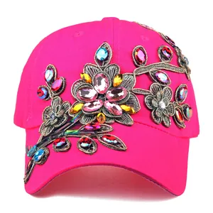 Close-up of luxury baseball cap with floral embroidery and colorful rhinestones detail