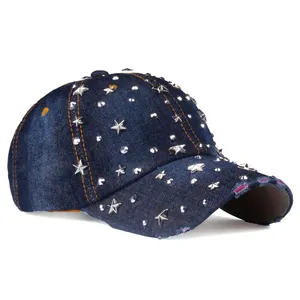 Distressed dark blue denim baseball cap with silver star studs and vintage punk style