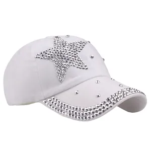 White fashion baseball cap with sparkling rhinestone star pattern and studded brim detail