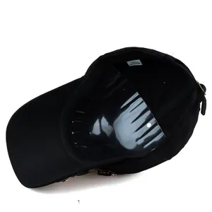 Inside view of black cotton baseball cap showing 100% cotton label and metal buckle