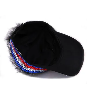 Macro view of black baseball hat with long grey wig hair and rhinestone details