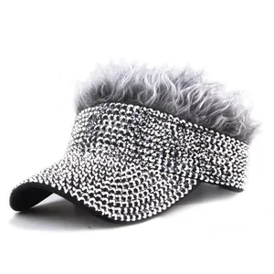 Detail view of sparkly rhinestones and fluffy grey synthetic hair on black visor hat