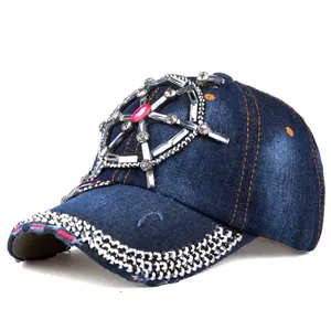 Detail of blue denim baseball cap with rhinestone ship wheel and frayed edges