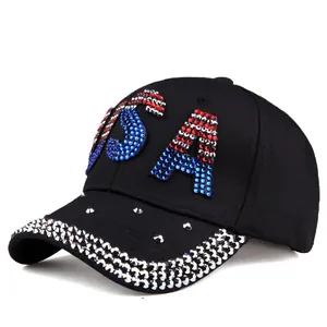 Detailed view of the sparkling rhinestone USA logo on a black denim baseball cap