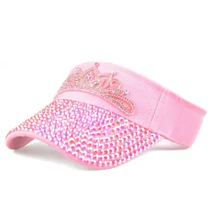 Detail of pink sun visor with crown rhinestones and glitter crystals on the brim