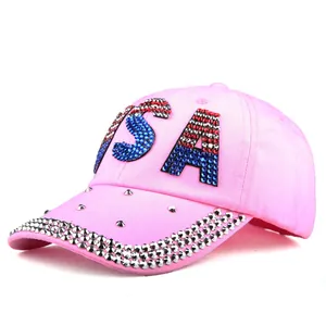 Detail of pink denim baseball cap with USA rhinestone lettering and silver metal studs
