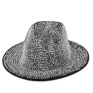 Detailed close-up of a silver rhinestone fedora hat with black bound edge trim