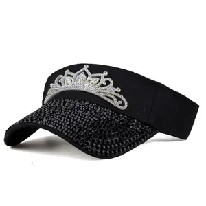 Detail of black sun visor hat featuring full rhinestone brim and sparkling silver crown