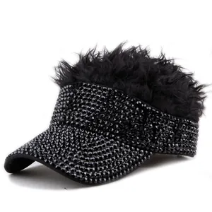 Close-up of black sun visor hat featuring sparkling rhinestones and synthetic hair piece