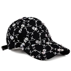 Black baseball cap with white floral embroidery and sparkling rhinestones for women
