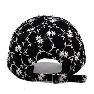 Rear view of black baseball cap with white floral embroidery and rhinestone accents