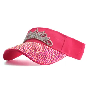 Detail of pink visor featuring shimmering rhinestones and a silver crown embellishment