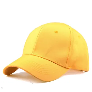 Detail view of the bright yellow cotton baseball cap showing woven texture and top eyelets