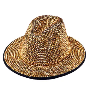 Detailed close-up of golden rhinestone embellishments on a black wool fedora stage hat