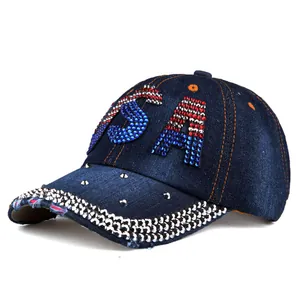 Close-up of USA rhinestone pattern and metal studs on distressed denim baseball cap