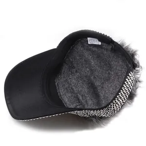 Detailed macro view of 100% cotton inner label and gray faux fur trim on a black cap