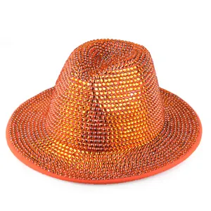 Detail of hand-set orange rhinestones on a wool felt fedora hat for stage performance