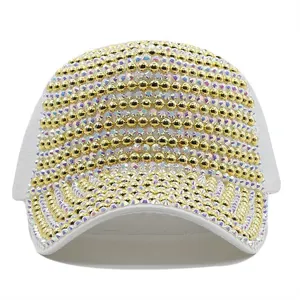 Detailed view of white baseball cap with gold beads and iridescent rhinestones