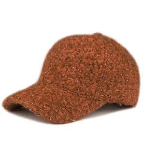 Close-up of caramel thick boucle textured baseball cap showing warm wool-like fabric detail