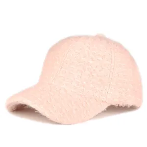 Detailed macro shot of the pink plush textured fabric on the warm winter baseball cap