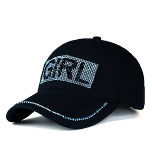 Close-up of black baseball cap featuring sparkling GIRL rhinestone lettering and brim detail