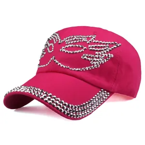 Detailed close-up of rose red baseball cap with silver rhinestone wing design and trim