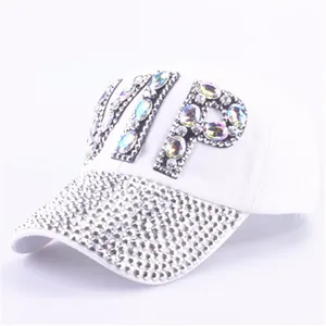 Detail of white baseball cap featuring VIP rhinestone letters and studded brim decoration