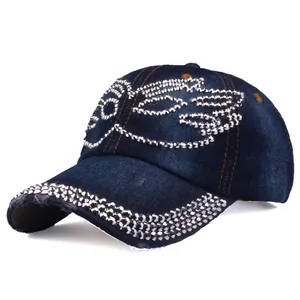 Detail of dark blue denim baseball cap with silver rhinestones and distressed brim