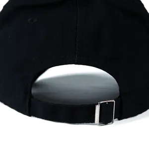 Adjustable back detail of a black baseball cap with a silver metal buckle closure