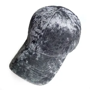 Detail of dark grey velvet baseball cap showing embossed texture and six-panel stitching