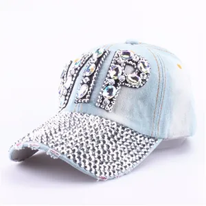 Detailed close-up of glittering VIP letters and rhinestones on the denim baseball cap