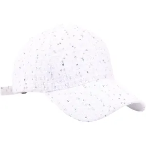 Close-up of white tweed baseball cap with colorful sequins and textured weaving details
