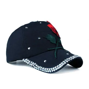 Navy blue baseball cap with red rose embroidery and sparkling rhinestones on brim
