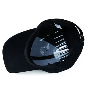 Internal view of black baseball cap showing 100% polyester fabric and metal buckle