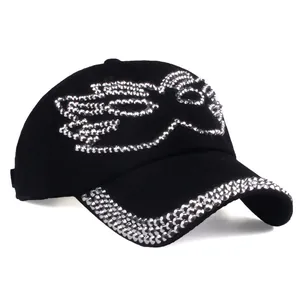 Women's black baseball cap with rhinestone wing design and shimmering brim detail