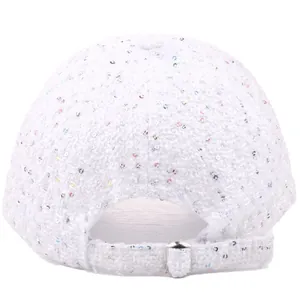 Macro detail of white tweed baseball cap back with silver buckle and colorful sequins