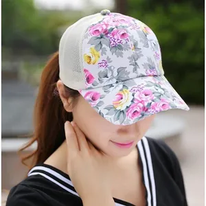 Close-up of women's floral trucker hat featuring pink roses and breathable mesh detail