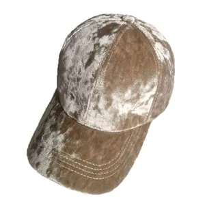 Detailed view of champagne velvet baseball cap with decorative brim stitching