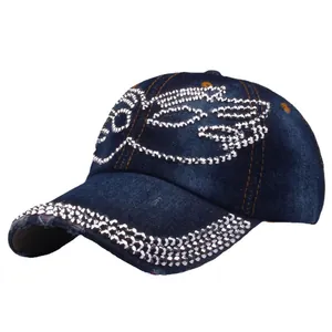 Women's blue denim baseball cap with crystal wing embellishments and frayed edges