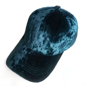 Detailed view of the dark green velvet texture and sheen on a baseball cap