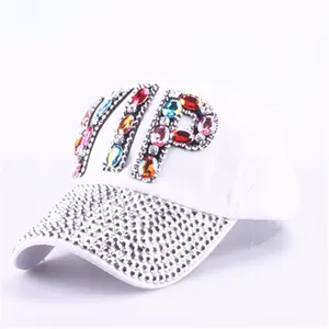 Macro detail of colorful VIP gemstone letters and silver rhinestones on a white cap