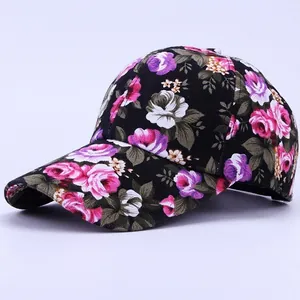 Side view detail of black floral baseball cap with pink rose and purple flower prints