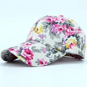 Detail shot of a canvas baseball cap featuring vibrant floral rose prints and patterns