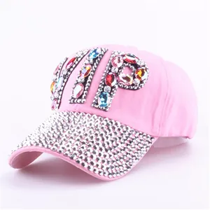 Close-up of pink baseball cap featuring rhinestone VIP letters and crystal brim details