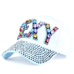 Close-up of light blue baseball cap with shiny colorful rhinestones on FLY lettering